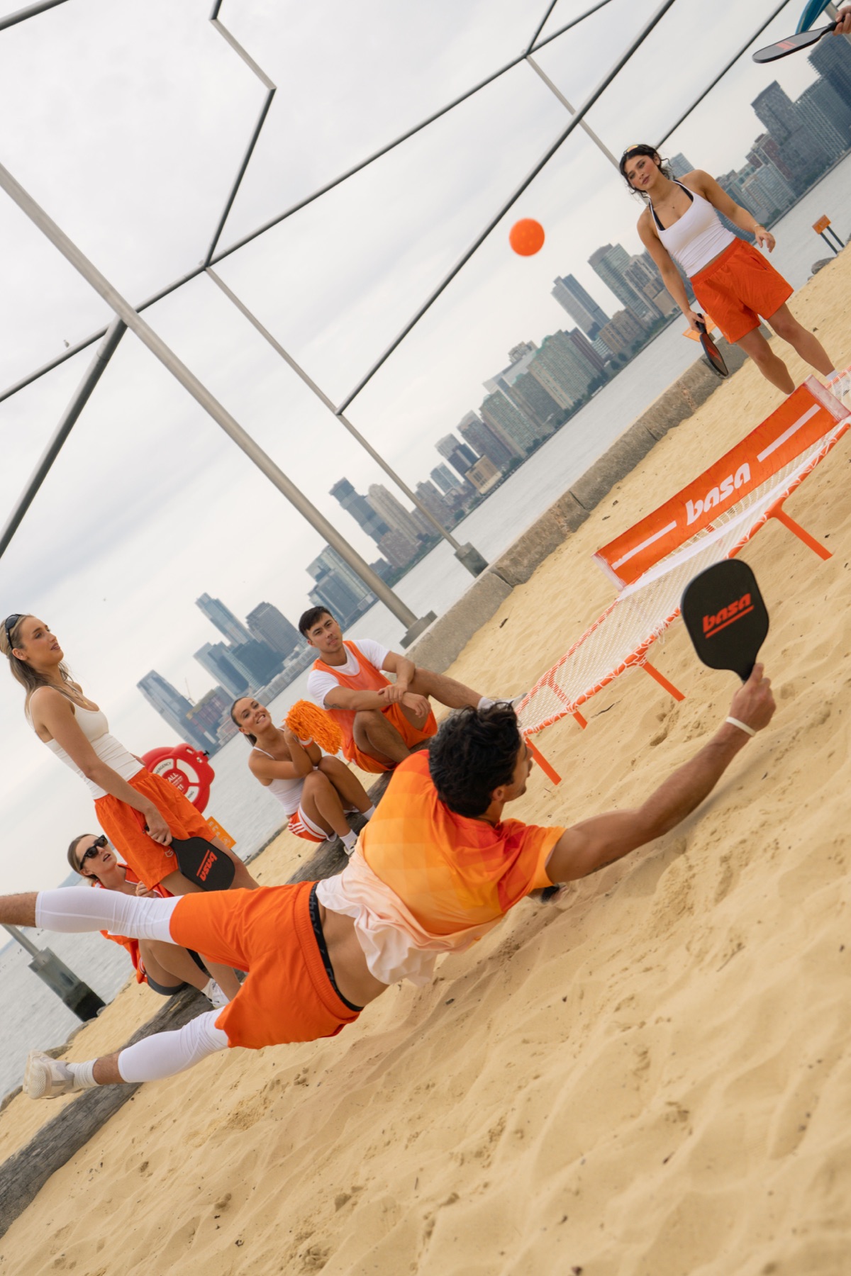 Player diving for the ball on the beach